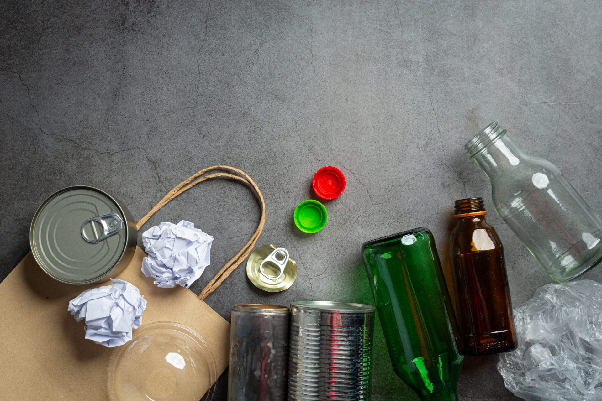 A small collection of plastic bottles on a gray background.